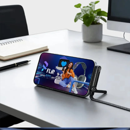 Smartphone with a Flipkart advertisement on a desk with a plant and notebook in the background