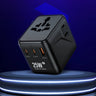 A black 25W GoN III Tech universal travel power adapter with multiple plug types and USB-C and USB-A ports, displayed on a glowing circular platform against a dark blue background.